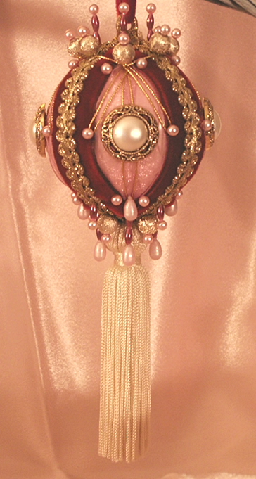 A stunning mauve and burgundy gift boxed Parlor Ornament with Ivory Tassel